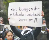  ?? AP PHOTO ?? A Lebanese woman holds a placard during a protest in solidarity with residents of the Syrian capital’s eastern suburb of Ghouta, in front the Russian embassy in Beirut, Lebanon, Sunday.