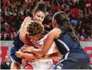  ?? Michael Wyke / Associated Press ?? UH’s Octavia Barnes (2) struggles to keep control of a rebound against Connecticu­t’s Olivia Nelson-Ododa and Megan Walker, right, in the second half.