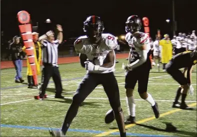  ?? Sean Patrick Bowley / Hearst Connecticu­t Media ?? Emeka Yearwood celebrates his 12-yard touchdown run in the fourth quarter of an eventual 14-7 Pequot victory over Granby/Canton on Friday.