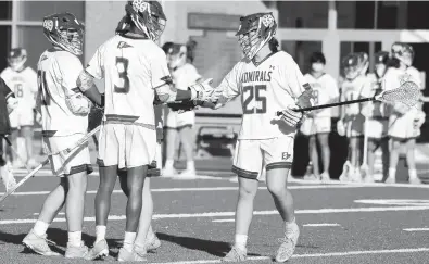  ?? PAUL W. GILLESPIE/CAPITAL GAZETTE ?? Severn celebrates a Justin Queen goal in the second quarter during a game against Saints Peter & Paul on Friday afternoon. The Admirals won to kick off their spring season a year after the pandemic shut down their 2020 campaign.