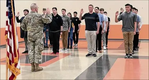  ?? Nina Borgeson / Army Training and Doctrine Command ?? Maj. Gen. Daniel Christian swears in new Army recruits at a military processing station in Albany before they ship off to basic training. The general, formerly of Lansingbur­gh, returned to the Capital Region for a “March to Service” mission.