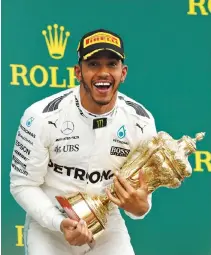  ?? REUTERS ?? MERCEDES’ Lewis Hamilton celebrates his win on the podium.
