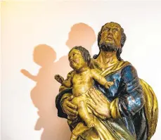  ??  ?? A statue depicting St. Joseph holding baby Jesus is seen at St. Joseph the Worker Church.