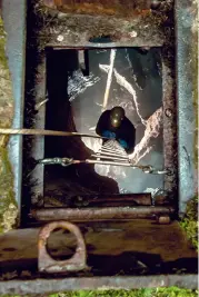  ??  ?? The cavers enter through a metal door in the ground, then descend a ladder