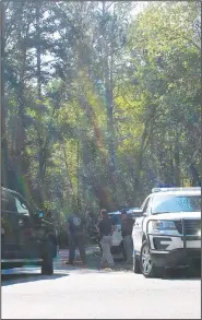  ?? AP/Polk County Standard Journal/KEVIN MYRICK ?? Polk County, Ga., law enforcemen­t officials look for a suspect involved in a shooting that killed a police officer and injured another Friday in Cedartown, Ga. The suspect, Seth Brandon Spangler, was taken into custody.