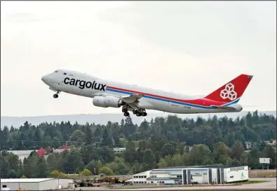  ?? Courtesy of Boeing Co. ?? A Luxembourg-bound 747-8 Freighter takes off from Seattle-Tacoma Internatio­nal Airport in this undated photo. The last two U.S. airlines that use 747s to carry passengers have said they will retire the planes by the end of the year.