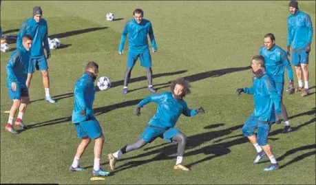  ?? AP ?? Real Madrid's Marcelo (centre) along with teammates during a training session in Madrid on Tuesday.