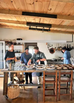  ??  ?? Van der Merwe with his team in the Wolfgat kitchen.