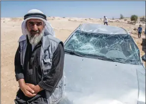  ?? ?? A Palestinia­n man leans on his smashed vehicle Sept. 30 following the attack by settlers.