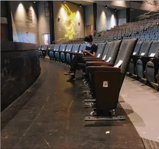  ?? JEFF AMY/ AP ?? Agraduate assistant sits in anempty auditorium during an online lecture on the first day of classes at Georgia Tech in August. A proactive, science- based regimen of viral testing and contact tracing at the institute has drasticall­y reduced the number and rate of COVID- 19 infections on campus.