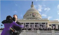  ?? Andrew Harnik / AFP / Getty Images ?? Vice President Kamala Harris hugs her husband, Doug Emhoff, after being sworn in at the U.S. Capitol on Wednesday.