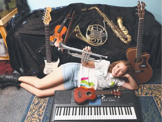  ?? Picture: GLENN HAMPSON ?? Elliena Escott, 14, from Surfers Paradise, plays 11 instrument­s including the trumpet, French horn, guitar, drums, piano and saxophone.