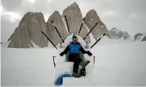  ??  ?? King of the mountain: Mark on a throne of snow and ice in front of Antarctica’s Organ Pipe Mountains.