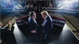  ?? JABIN BOTSFORD/THE WASHINGTON POST ?? Former President Donald Trump (right) shakes hands with North Dakota Gov. Doug Burgum, who is leading the Trump campaign’s developmen­t of its energy policy, at a Jan. 22 rally. Burgum decries the Biden administra­tion’s “hostile attack against all American energy.”