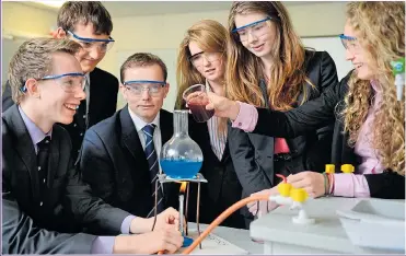  ??  ?? GOOD CHEMISTRY: pupils at a Cheshire grammar school enjoy a sound education