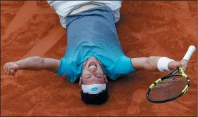  ?? AP PHOTO/MICHEL EULER ?? Italy’s Marco Cecchinato lays on the clay as he defats Serbia’s Novak Djokovic during their quarterfin­al match of the French Open tennis tournament at the Roland Garros stadium, Tuesday in Paris.