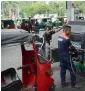  ?? AFP ?? Sri Lankan drivers fill up their auto rickshaws at a gas station in Colombo on Wednesday. —