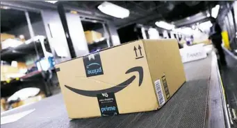  ?? Mark Lennihan/Associated Press ?? A package from Amazon Prime moves on a conveyor belt at a UPS facility in New York. Amazon’s Prime Day this year will be six hours longer than last year’s and will launch new products.