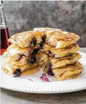  ?? Carl Tremblay / America's Test Kitchen ?? These pancakes are sprinkled with blueberrie­s, but other add-ins work well, too.