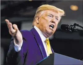  ?? Evan Vucci The Associated Press ?? President Donald Trump speaks at a rally Friday in Lake Charles, La. He said Democrats were using an impeachmen­t inquiry to try to overturn the 2016 election.