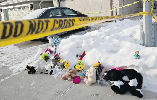  ?? JASON FRANSON/THE CANADIAN PRESS ?? Flowers and stuffed animals lay on the sidewalk this week as Edmonton police investigat­e the scene of a fatal multiple shooting in a north-end home.