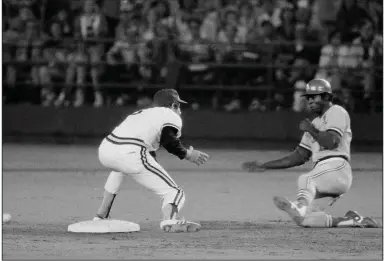  ??  ?? Lou Brock of the St. Louis Cardinals slides into second base as the ball eludes San Diego shortstop Bill Almon on Aug. 29, 1977, in San Diego. Brock set the major league record for stolen bases with the steal. Brock’s record would later be broken by Rickey Henderson. (AP file photo)