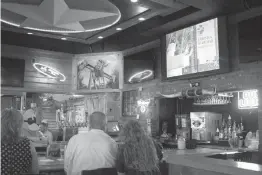  ?? Staff photo by Kayleigh Moreland ?? Board members and supporters of CHRISTUS St. Michael Friends of the Foundation watch a video Wednesday at Texas Roadhouse during an event to introduce this year’s Great Texarkana Duck Race. Friends of the Foundation has been planning for the fundraiser...