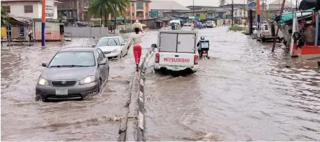  ?? Photo: NAN ?? Vehicles wade through flood along Egbeda-Akowanjo road in Lagos, after a heavy downpour yesterday