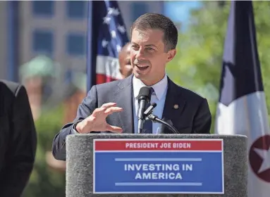  ?? JENNA WATSON/INDYSTAR ?? U.S. Secretary of Transporta­tion Pete Buttigieg speaks Aug. 31 outside Cummins Indianapol­is Distributi­on Headquarte­rs in downtown Indy. Buttigieg made several stops in Indiana to highlight infrastruc­ture investment­s the Biden administra­tion has made.