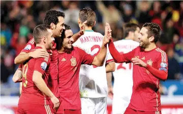  ??  ?? Spain’s midfielder Sergio Busquets (2L) celebrates after scoring against Belraus during the UEFA Euro 2016 qualifying football match Spain vs Belarus at the Estadio Nuevo Colombino in Huelva on November 15, 2014. - AFP photo