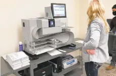  ?? TOM SHORTELL/THE MORNING CALL ?? An election worker waits as a tabulation machine scans mail-in ballots Tuesday at the Northampto­n County Courthouse.