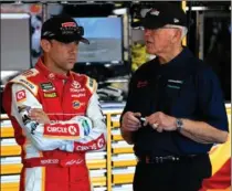  ?? JEFF SINER, TNS ?? Matt Kenseth and team owner Joe Gibbs talk in the garage at Charlotte Motor Speedway.