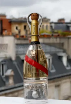  ??  ?? A bottle of Mumm Grand Cordon Stellar champagne that will be drank by space tourists using a container bottle adapted to pour the bubbly liquid in zero gravity conditions. — AFP photos