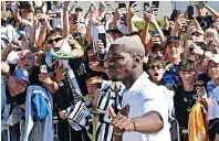  ?? ?? THUMBS UP Paul Pogba is mobbed by fans as he arrives at the J Medical centre in Turin to undergo medical tests ahead of his free transfer from Manchester United back to Juventus