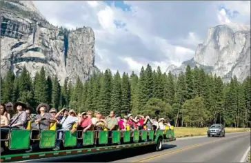  ?? MAX WHITTAKER/THE NEW YORK TIMES ?? Tourists ride through Yosemite National Park in California, on August 27, 2013. Advance planning may be in order if you want to camp at a popular national park or ride the latest roller coaster.