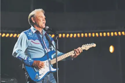  ?? Amy Harris, Invision file ?? Glen Campbell performs in 2012 at the CMA Music Festival in Nashville, Tenn. Campbell, who died Tuesday, won five Grammys, sold over 45 million records, and had 12 gold albums and 75 chart hits, including two No. 1 songs.