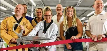  ?? MICHAEL D. CLARK / STAFF ?? Two-time Olympic judo champion Kayla Harrison was heralded as a hero Saturday as she joined Middletown Mayor Larry Mulligan Jr. (right) in helping open a new martial arts studio in Middletown.