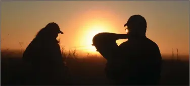  ?? (Arkansas Democrat-Gazette/Bryan Hendricks) ?? Anne Marie Doramus (left) and Jim Harris gather decoys at sunrise Monday after a successful goose hunt in southeast Arkansas.