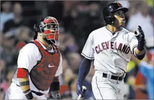  ?? Charles Krupa ?? Greg Allen follows through on a go-ahead home run in front of Red Sox catcher SandyLeon in the seventh inning of the Indians’ 5-4 win Monday at Fenway Park. Cleveland had three homers and overcame a 3-0 hole.The Associated Press