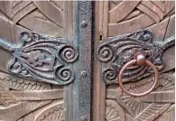  ??  ?? Nature motifs in the wrought-iron latches on the heavily carved wooden doors to the chapel.