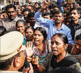  ?? REUTERS ?? Demonstrat­ors argue with a police officer during a protest against the rape and murder of a 27-year-old woman in Shadnagar, on the outskirts of Hyderabad, on Saturday.