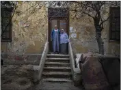  ?? HEBA KHAMIS — THE NEW YORK TIMES ?? Fathy, who did not want his last name used, and his wife, Mona, stand outside their home next to the tomb of Neshedil Qadin, a consort of a 19th-century Egyptian ruler.