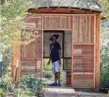  ??  ?? Timothy Hammond checks out a “Curiosity Cabinet” during a sneak preview of the Houston Botanic Garden on Tuesday.