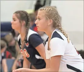  ?? Scott Herpst, file ?? Saddle Ridge libero Lanie Hamilton (right), along with Addison McNabb (left) await a serve during match earlier this season. The Lady Mustangs kept pace for the No. 1 seed in the NGAC tournament by beating previously-unbeaten Ringgold last week.