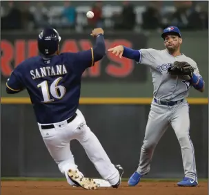  ?? The Associated Press ?? TWO FOR ONE: Milwaukee Brewers’ Domingo Santana (16) is tagged out at second as Devon Travis turns a double play on a ball hit by Jett Bandy in the second inning of Toronto’s 8-4 win Wednesday in Milwaukee.