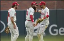  ?? BRYNN ANDERSON — THE ASSOCIATED PRESS ?? Phillies right fielder Nick Castellano­s (8) celebrates his catch for an out with Brandon Marsh (16) and Matt Vierling (19) during the ninth inning in Game 1of the NLDS against the Braves on Tuesday in Atlanta.