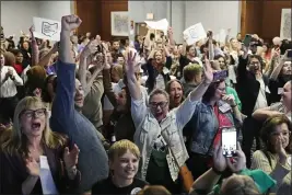  ?? SUE OGROCKI — THE ASSOCIATED PRESS ?? Issue 1supporter­s cheer as they watch election results come in Tuesday in Columbus Ohio. Ohio voters have approved a constituti­onal amendment that guarantees the right to abortion and other forms of reproducti­ve health care.