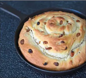  ?? (TNS/Pittsburgh Post-Gazette/Lucy Schaly) ?? This Potato-Raisin Bread Spiral, made in a cast-iron skillet, is a nod to the old Irish fruit pan breads. The potato keeps the bread moist and flavorful for days and raisins add a natural sweetness.