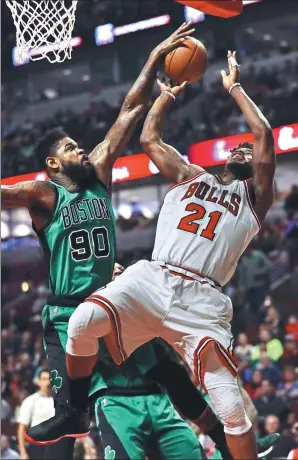  ?? JONATHAN DANIE / AFP ?? Amir Johnson of the Boston Celtics blocks a scoring attempt by Jimmy Butler of the Chicago Bulls at United Center in Chicago on Thursday. The Bulls won 104-103.
