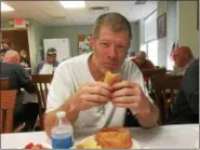  ?? ZACH SRNIS — THE MORNING JOURNAL ?? Marion Eakle, U.S. Marine Corps veteran, enjoys a meatball sub June 6 prepared by the Italian American Veterans Post 1 Ladies Auxiliary.